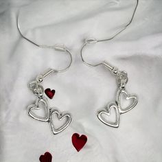 Our enchanting double heart Earrings - a whimsical blend of elegance and charm designed for special occasions such as birthdays, Valentine's Day, Mother's Day, or any moment you want to make unforgettable. Crafted with meticulous attention to detail, these earrings are designed to captivate with 2 hollow hearts pendant suspended from French wire hooks. The hooks, plated with 14k white gold, ensure both style and hypoallergenic comfort for all-day wear. The double heart pendant, made from silver- Hypoallergenic Drop Earrings For Valentine's Day, Metal Dangle Heart Earrings With Heart Charm, Heart Charm Metal Earrings For Gift, Metal Heart Pendant Earrings For Gift, Mother's Day Dangle Heart Earrings, Anniversary Jewelry With Heart Pendant And Matching Earrings, Mother's Day Heart Dangle Earrings, Metal Heart Pendant Earrings For Anniversary, Gift Drop Earrings With Dangling Charms