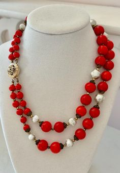 This listing is for a vintage, unsigned necklace of gorgeous red beads. Extending to 17" in length, the double-strand necklace has shiny red art glass beads, some with gold tone filigree caps, and gold tone bead spacers. Interspersed are white glass beads which were, at one time, painted silver. The paint has since worn which I think only enhances their charm. The box clasp is secure. A lovely holiday necklace! Jewelry will be securely packaged in a gift box. Please note that all of my items hav Holiday Necklace, Double Strand Necklace, Red Beads, Box Clasp, Red Art, Double Ring, Red Bead, Strand Necklace, Necklace Jewelry