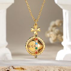 The pendant features a delicate circular frame adorned with an array of vibrant colored stones. At its heart lies a captivating surprise – a dice that gracefully rotates 360°, symbolizing the unpredictability of life's adventures. This unique piece not only reflects your sophisticated taste. Adorn yourself with this exquisite necklace, and let the world witness your flair for both beauty and whimsy.Carat Weight: 0.994 ctStone Size: 1.5,1.6,1.8,2,1.5,1.5 mmNumber of Stones: 73 Stone Color: Garnet Round Pendant Jewelry With Rotating Bezel Gift, Rotating Bezel Round Pendant Jewelry As A Gift, Gold Multi-stone Spiritual Necklace, Gold Multi-stone Necklace With Spiritual Style, Gold Spiritual Necklace With Multi-stone, Spiritual Gold Necklace With Multi-stone Details, Gold Multi-stone Round Pendant Jewelry, Multicolor Round Amulet Pendant Jewelry, Spiritual Multi-stone Round Jewelry