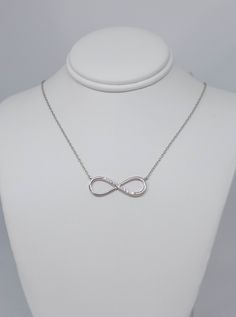 Beautiful sterling silver infinity Necklace with this cubic zirconia, Inspired by ancient infinity signs, meaning eternal connection It like the endless love between lovers, families, and friends. I recommend putting your jewelry on last when getting ready, as direct exposure to hair-styling products and perfume will often also damage the metal and gemstones. Do NOT use jewelry when swimming in chlorinated, thermal or salt water OR when showering. Also avoid wearing silver while exercising as th Silver Infinity Jewelry, Silver Infinity Jewelry For Anniversary, Infinity Cubic Zirconia Necklace For Mother's Day, Cubic Zirconia Infinity Jewelry For Mother's Day, Hypoallergenic Sterling Silver Infinity Jewelry, Hypoallergenic Infinity Sterling Silver Jewelry, Mother's Day Cubic Zirconia Infinity Necklace, Mother's Day Infinity Necklace With Cubic Zirconia, White Gold Infinity Jewelry With Cubic Zirconia