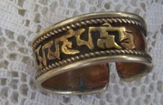 Vintage Middle East Band Ring...Copper Over Silver....Gold Tone Writing...Adjustable....Size 8...Add On Ring Interesting vintage ring...center copper band shows wear---silver tone metal...center writing is gold tone metal...silver tone metal border. Ring measures approx. size 8...slightly adjustable...unsigned. I am not familiar with writing on top of ring. Thanks for viewing. Vintage Middle East, Vintage Ring, Gold Tone Metal, Middle East, Band Ring, Vintage Rings, Band Rings, Hippie Boho, Cuff Bracelets