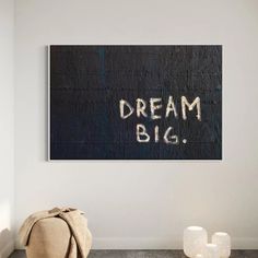 a black and white photo with the words dream big written on it next to a bag