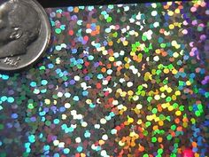 a coin sitting on top of a table covered in confetti