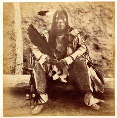 an old black and white photo of a native american man