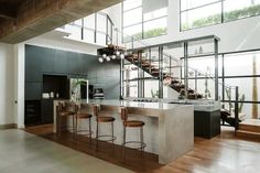 an open kitchen and living room with stairs