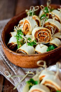 a wooden bowl filled with food on top of a table