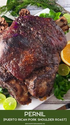 a large piece of meat sitting on top of a white plate next to sliced oranges