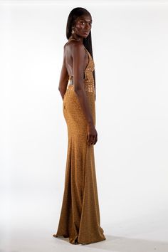 The Alison is a show-stopping statement piece, a maxi gown drenched in golden glamour. Picture yourself draped in cascading layers of crystalized rhinestones, each catching the light with an irresistible shimmer. The square neckline adds a touch of modern edge, while the metallic charm whispers of individuality. This isn't just a dress, it's a conversation starter. Be the epitome of audacious elegance – own your night in the Alison. Luxury Gold Maxi Dress For Evening, Luxury Embellished Evening Dress For Glamorous Events, Glamorous Gold Evening Dress With Sweep Train, Gold Sparkling Sequin Dress For Evening, Glamorous Gold Embellished Evening Dress, Sequin Floor-length Gown For Glamorous Events, Floor-length Sequined Gown For Glamorous Events, Gold Embellished Maxi Dress For Gala, Glamorous Gold Gown For Gala