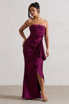 Look no further for the perfect wedding guest dress. meet Ace. This plum maxi dress expertly cut in our premium satin features a strapless neckline and gathered skirt. Ace showcases a bold thigh split complemented by a ruffle that drapes effortlessly down the skirt. Pair yours with simple gold accents and some strappy stilettos for your next occasion.Features- Premium satin- Bandeau neckline - Strapless- Invisible zip closure - Ruffle drape detail- Thigh split - Maxi length Sizing & Fit Model is Perfect Wedding Guest Dress, Plum Bridesmaid Dresses, Midi Bridesmaid Dress, 2025 Wedding, Club L London, Black Dress Prom, Strappy Stilettos, Black Tie Gala, Split Maxi Dress