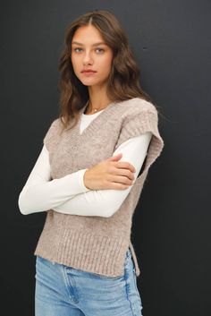 Stay warm and stylish with our Wool Blend V-Neck Sweater Vest. This sleeveless sweater vest features ribbed ends and a v-neck, with stitch detailing down the center. Made from a soft wool blend, it's perfect for layering during the fall and winter, adding a touch of preppy style to your everyday look. 70% Polyester, 22% Nylon, 8% Wool Sleeveless Sweater Vest, Chic Holiday, Cocktail Mix, Loose Fabric, Winter Layering, Gift Boutique, Sleeveless Vest, Sleeveless Sweater, Soft Wool