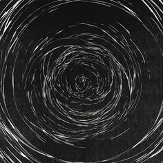 an abstract black and white photo with circles in the center, all drawn by hand