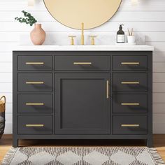 a bathroom vanity with a round mirror above it and a rug on the floor next to it