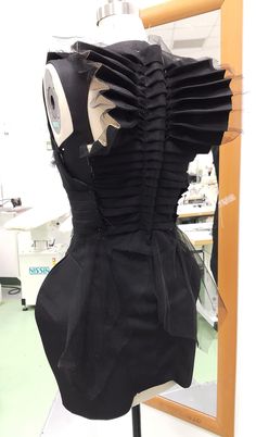 the back of a dress made out of black material