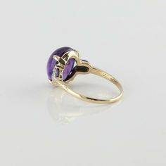 Vintage 10K Yellow Gold Amethyst Cabochon and Diamond Ring, 10 x 12mm oval medium dark amethyst high dome cabochon, 6 diamonds set in white gold, tulip shapes to sides, 7/16 inch across, polished engraved designs mid shank, Ring size 7.25, Circa 1950, 3 grams SKU# BB285R04 This listing contains photographs of the actual item you will receive. Our items are in excellent condition with little or no signs of wear and many are one of a kind pre-owned estate finds. Please look closely at the pictures Dark Amethyst, Sparkly Ring, Gold Diamond Band, Amethyst Gem, Purple Band, Fine Jewelry Designers, Boston Ma, Blue Topaz Ring, Topaz Ring