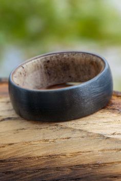 a wooden ring sitting on top of a piece of wood