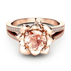 a rose shaped ring with diamonds on the sides and an oval pink stone in the center