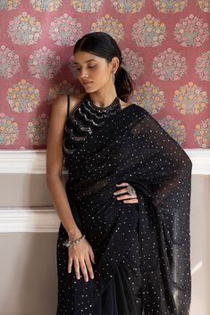 Beautiful black sequin embroidered saree. It comes with a sequined work all over and a sleeveless sequined blouse. It is best suited for night parties & weddings. Shop designer saris online in the USA from Pure Elegance Disclaimer: The actual product may vary slightly from the image. These are custom orders, hence expect slight variation in color, placement of the motif or buta. ESTIMATED DELIVERYBecause this is a custom order, it would take about 4 weeks from the date of purchase. RETURN POLICY Black Organza Saree, Sequined Blouse, Suits Indian, Night Parties, Sharara Suits, Embroidered Saree, Fashion Journals, Anarkali Suits, Organza Saree