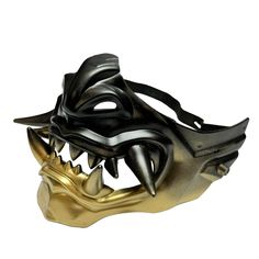 a gold and black mask with spikes on it