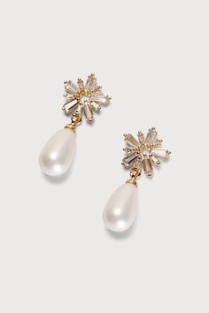 The finishing touch to all your best looks is the Lulus Pearl-fectly Pretty Gold Rhinestone Pearl Drop Earrings! These understated (yet eye-catching) earrings feature a glowing faux pearl teardrop that falls from baguette-cut rhinestones arranged to form a stud with a star-inspired shape. Post backs. 1'' Long. 40% Brass, 30% Cubic Zirconia, 30% Plastic. Imported. Lulus | Pearl-fectly Pretty Gold Rhinestone Pearl Drop Earrings. Glamorous Teardrop Pearl Earrings For Party, Pearl Teardrop Crystal Earrings For Party, Party Pearl Teardrop Crystal Earrings, Party Teardrop Pearl Crystal Earrings, Gold Rhinestone Earrings, Bridal Earrings Drop, Gold Bridal Earrings, Faux Pearl Earrings, Bride Earrings