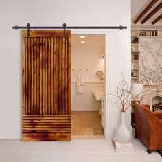 a living room with an open wooden door