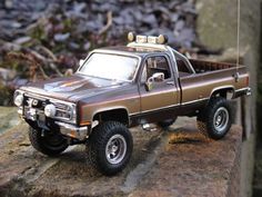 a toy truck is sitting on some rocks