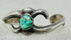 Sand cast vintage Hopi cuff has an elegant shape and features a center green turquoise stone. Cuff was acquired from a private collection in Missouri. For more information, please call 702-301-2252. Precious metal: Sterling Silver Stone: Turquoise Size: 6 1/4 Gap: 1 1/2" Weight: 25.39 g Measurements: Tribe: Hopi Hallmark: None Circa: 1950s Elegant Green Turquoise Ring, Elegant Turquoise Bracelets With Patina, Elegant Turquoise Bracelet With Patina, Vintage Green Cuff Bracelet For Formal Events, Vintage Green Cuff Bracelet For Formal Occasions, Green Vintage Cuff Bracelet For Formal Occasions, Vintage Turquoise Jewelry With Oxidized Finish, Green Vintage Formal Cuff Bracelet, Green Patina Bracelet