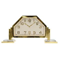 a gold and white clock sitting on top of each other