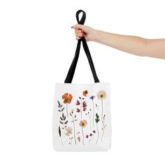 Pressed Wildflowers Tote Bag. This practical, high-quality Tote Bag is available in three sizes. Made from reliable materials, lasting for seasons. *Shipping up to 2 - 5 business days* 100% Polyester Boxed corners Black inner stitching, transparent thread on hems. Black cotton handles With non-woven laminate inside Size tolerance 0.75" (1.9 cm)) Assembled in the USA from globally sourced parts Small Medium Large Height, in 13.00 16.00 18.00 Length, in 12.00 15.00 17.00 Width, in 3.46 3.46 3.46 H Everyday Floral Print Shoulder Bag With Double Handle, Everyday Floral Print Double Handle Shoulder Bag, Floral Print Double Handle Shoulder Bag For Everyday, Daily Use Floral Print Satchel Shoulder Bag, Daily Use Floral Print Shoulder Satchel, Eco-friendly Floral Canvas Bag For Everyday Use, Floral Print Tote Satchel For Daily Use, Daily Use Floral Print Shoulder Bag With Double Handle, Daily Use Floral Print Double Handle Shoulder Bag