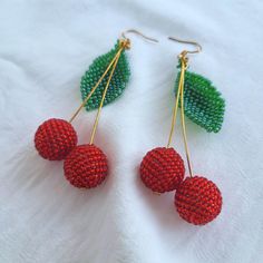 Stand Out with These Playful Cherry Earrings! Who's this for? Looking for a unique accessory to add a touch of personality to your outfit? These cherry earrings are the perfect choice for anyone who loves: Fun and playful jewelry Bright and vibrant colors Unique and eye-catching designs Comfortable and lightweight accessories Characteristics: Handmade with high-quality Czech glass beads Features vibrant red and green cherries Lightweight and comfortable to wear Gold-plated findings for a touch of elegance Versatile and can be paired with any outfit Why it's worth buying: Adds a pop of color and personality to any outfit Makes a perfect gift for a friend or loved one Crafted with attention to detail and high-quality materials Affordable and stylish Ready to add a touch of whimsy to your war Trendy Handmade Cherry-colored Jewelry, Handmade Cherry Jewelry For Party, Cherry Party Jewelry For Pierced Ears, Cherry Colored Drop Earrings With Ear Wire, Cherry Dangle Earrings With Ear Wire, Cherry Drop Earrings With Ear Wire, Cherry Color Dangle Earrings, Cherry Dangle Earrings For Party, Fun Red Beaded Earrings For Gift