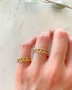 Dress up your everyday basics with this Cuban Chain Ring, expertly crafted in glowing 14K gold with the option of Diamonds. Add a couple of delicate fine rings to this beauty!! Your chain necklaces can now be paired with a sleek matching ring. This modern-luxe link band adds instant sophistication. Metal: 14K Yellow Gold (Stamped) Chain Width: 5 mm Stone: Diamonds Size Option: 6, 6.5, 7, 7.5, 8, 8.5 Stackable Yellow Gold Chain Ring For Promise, Adjustable Chain Gold Plated Open Ring, Adjustable Gold Plated Open Chain Ring, Gold Chain Jewelry With Open Ring Design, Gold Jewelry With Chain Detail In Open Ring Shape, 14k Gold Open Chain Ring For Promise, Stackable Open Chain Ring For Promise, Gold Chain Link Jewelry With Metal Ring, Gold Plated Chain Rings As Gift