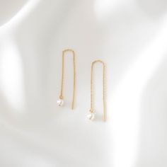 A pair of 14K solid gold threader earrings with a genuine freshwater pearl. Comes with gift box.  Threader earrings measure approximately 3 inches in length. These earrings are made of all 14K solid gold and 4mm freshwater pearl. Anti-tarnish, nickel-free, and waterproof.  This is a lifetime piece. --------------------♥ PROMOS ♥-------------------- Want 10% off? Join the mailing list by visiting http://bit.ly/vedern . Just leave me a note at checkout if you have any problems applying discount codes. --------------------♥ BUY WITH CONFIDENCE ♥-------------------- Don't love it? Message me to set up a return or exchange. If you find any problems with your items, just send a message with a photo, and a new one will be on its way to you! --------------------------♥ PACKAGING ♥----------------- Delicate Pearl Charm Threader Earrings Gift, Yellow Gold Dangle Threader Earrings Gift, Gold Threader Earrings Fine Jewelry Gift, Gold Threader Earrings As Gift, Hypoallergenic Yellow Gold Threader Earrings Gift, Dainty Pearl Charm Threader Earrings Gift, Gift White Pearl Charm Threader Earrings, Dainty Threader Earrings With Pearl Drop Gift, Dainty Threader Earrings With Pearl Charm As Gift