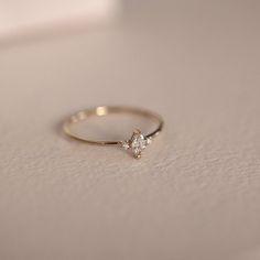 a diamond ring sitting on top of a table