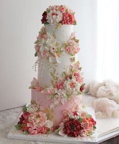 a three tiered wedding cake decorated with flowers