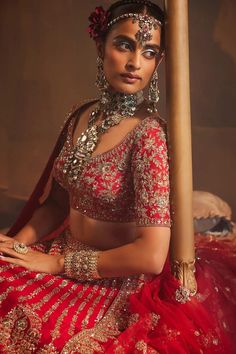 Red attached cancan lehenga with zardozi, thread, sequin embroidery in floral pattern. Paired with half sleeve padded blouse and scallop border embroidered dupatta.
Components: 3
Pattern: Embroidery
Type Of Work: Zardozi, thread, sequin
Neckline: Leaf neck
Sleeve Type: Half sleeves
Fabric: Raw Silk
Color: Red
Other Details: 
Lehenga:
Attached cancan
Floral pattern
Length: Approx 43 - 44 inches
Blouse:
Padded
Dupatta:
Embroidered borders
Semi sheer
Note: All the jewellery worn by the model is not Red Sets With Tilla In Traditional Drape, Red Sets With Tilla Detail And Traditional Drape, Red Festive Tilla Sharara, Red Tilla Choli For Navratri, Red Bollywood Choli With Tilla Detail, Bollywood Style Red Choli With Tilla Details, Festive Red Sets With Tilla Details, Festive Red Tilla Sets, Red Fitted Sharara With Tilla