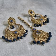 This listing is for Indian style Navy blue earrings and Maang Tikka set. These stunning earrings are crafted to enhance your style, whether you're attending a party or a wedding ceremony. They are guaranteed to make you stand out in the crowd. Elevate your style with these stunning dark blue earrings tika set. Make a bold fashion statement and turn heads wherever you go. Shop my stunning collection today! In addition to these earrings, I offer various hand-crafted Indian and Pakistani jewelry st Blue Dangle Danglers For Wedding, Blue Earrings For Festivals And Celebrations, Blue Earrings For Celebration Festivals, Festive Party Pearl Earrings, Festive Party Danglers For Pierced Ears, Blue Festive Danglers, Hand Set Chandelier Earrings For Parties And Festivals, Hand Set Hoop Earrings For Party, Blue Bollywood Jewelry Sets For Gift