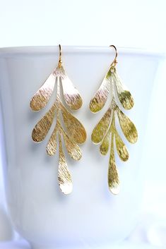 Leaf Earrings golden. Nature Earrings. Statement earrings 18k gold plated. These beautiful leaf earrings are inspired by nature and make a great statement jewelry piece. The gold plated brass pendant is beautifully textured. The earrings are lightweight and comfortable to wear. ❤ Handmade with love I High quality workmanship I Lovingly packaged. ❤ DETAILS Brass 18k gold plated 70x29 mm The earrings are delivered in a elegant jewelry box. ❤ More gold earrings here: https://www.etsy.com/de/shop/Gl Gold Leaf Earrings For Gift, Yellow Gold Leaf Earrings, Gold Single Leaf-shaped Earring, Gold Leaf-shaped Earrings For Gift, Gold Leaf-shaped Pierced Earrings, Gold Leaf-shaped Single Earring, Gold Leaf-shaped Earrings, Yellow Gold Leaf-shaped Earrings For Pierced Ears, Gold-plated Leaf-shaped Earrings