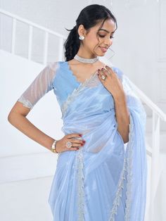 Introducing our stunning "fascinating light blue swarovski work organza saree with a blouse," a true masterpiece that will make you stand out at any occasion. Made from high-quality organza material, this saree is adorned with intricate Swarovski work all over, adding a touch of elegance and luxury to your look. The heavy handwork border further enhances the beauty of this saree, making it a must-have in your ethnic wardrobe.
The light blue color exudes charm and sophistication, while the flowy Organza Saree With Blouse, Engagement Gown, Organza Material, Lehenga Crop Top, Lehenga Choli Wedding, Floral Lehenga, Party Wear Lehenga Choli, Reception Gown, Bollywood Lehenga