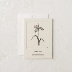 a card with a flower on it that says thank you in black and white ink