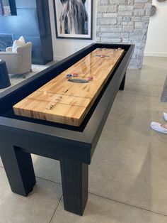 a table that has some kind of board game on it in a room with pictures