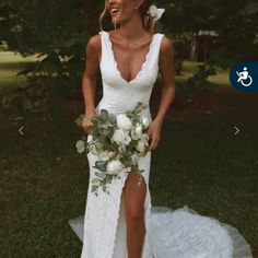 a woman in a white wedding dress holding a flower bouquet and smiling at the camera