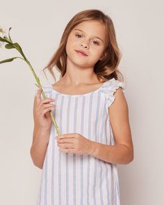 The Amelie Nightgown has stunning attention to detail made of the finest lightweight woven cotton and ruffle trim on shoulders. The sleepwear is made from the finest quality yarn-dyed cotton and blended with just enough inherently flame retardant fiber to allow it to pass strict CPSC flame retardant laws without using harmful chemicals. The fabric is brushed for added softness, making the sleepwear feel absolutely luxurious, getting cozier after each wash. In our luxurious sleepwear, your little Cotton Nightgown For Spring Pajama Party, Cotton Beach Nightgown With Ruffles, Beach Nightgown With Ruffles In Cotton, Spring Ruffled Pajamas For Pajama Party, Ruffled Sleepwear For Summer Sleepovers, Spring Cotton Nightgown For Bedtime, Blue Cotton Sleepwear With Ruffles, Spring Beach Nightgown With Ruffles, Beach Nightgown With Ruffles For Spring