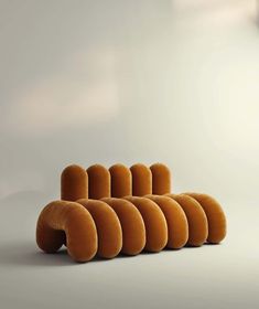 a group of orange curved objects sitting on top of a white floor next to each other