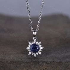 This beautiful Art Deco Galaxy Blue Sandstone Necklace features 1 carat round shaped center stone surrounded by Moissanite/Simulated Diamonds. For those who are looking for agate jewelry which is handcrafted in details, this unique agate necklace would be a perfect choice for you. Whether it be a Birthday gift for her, an anniversary gift her, or a celebration of yourself, this agate jewelry is the perfect gift from the heart. Alexandrite necklace: www.etsy.com/listing/1337968988/1ct-lab-alexand Fine Jewelry Sapphire Necklaces For Anniversary, Sapphire Jewelry With Moissanite Accent Stones, Sapphire Necklace With Prong Setting For Anniversary, Sapphire Necklace With Prong Setting For Wedding, Anniversary Sapphire Necklace With Prong Setting, Blue Round Stone Jewelry For Wedding, Fine Jewelry Sapphire Gemstone Necklaces, Round Wedding Necklace With Center Stone, Round Diamond Necklace With Center Stone For Wedding