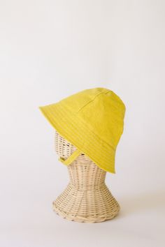 "This yellow baby and toddler summer sun hat is the perfect thing for sunny days!  Washable linen makes it an easy go to for at the park, the beach, or even the backyard!  This hat will protect delicate baby skin from the sun and will quickly become a favorite accessory! I made this sun hat from a bright yellow linen for a fun day in the sun.  The strap closes with snaps under the chin keeps them from pulling it off.  Brim measures approx. 2.25 inches. SIZES AVAILABLE 0-3 mos. - fits 14\" to 16\ Summer Lightweight Adjustable Bucket Hat, Adjustable Cotton Summer Hat, Adjustable Solid Bucket Hat For Summer, Playful Adjustable Summer Hat, Playful Summer Hats With Adjustable Fit, Adjustable Cotton Bucket Hat For Summer, Adjustable Summer Cotton Bucket Hat, Summer Cotton Bucket Hat With Adjustable Fit, Adjustable Fit Solid Color Summer Bucket Hat