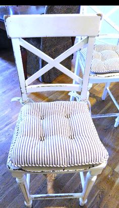 two chairs sitting next to each other on top of a wooden floor