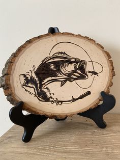 a wood slice with a fish on it