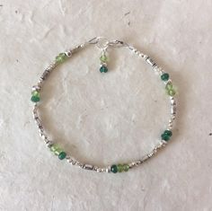 Nickel-free Green Beaded Bracelets, Adjustable Green Bracelets With Silver Beads, Adjustable Green Bracelet With Silver Beads, Green Bracelets With Silver Beads As Gift, Handmade Green Bracelets For Birthday, Green Nickel Free Bracelets With Round Beads, Handmade Adjustable Beaded Bracelets For May Birthstone, May Birthstone Faceted Beads Bracelet, Green Beaded Bracelets With Silver Beads For Gifts