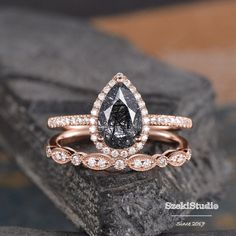 an engagement ring set with a pear shaped black diamond