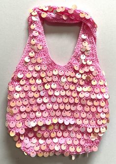 a pink purse with lots of buttons on it