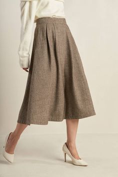 A woven full skirt with front pleat and back zipper closure Details: Self : 100% Polyester Size & Fit - Model is 5`8" And Wearing Size Small- Measurements Taken From Size Small- Approx. Length: 33" Chic A-line Winter Bottoms, Beige A-line Pleated Skirt For Fall, Fall A-line Skirt With Pleated Hem, Flowy A-line Skirt For Fall, Fall Wide Leg Lined Skirt Bottoms, Fall Wide Leg Lined Bottoms, Winter Beige Pleated Skirt, Fall Flared Skirt Bottoms With Pockets, Fall Flared Skirt With Pockets